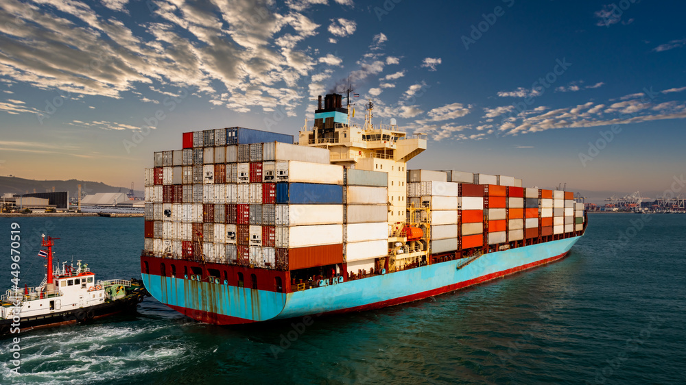 Obraz premium container cargo ship carrying commercial container in import export business commerce logistic and transportation of international by container ship at morning