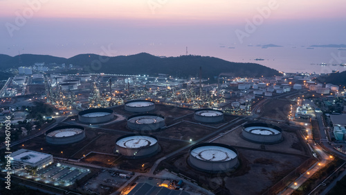 Aerial view industry factory oil and gas chemical tank and oil refinery plant zone and mountain ship in sea background