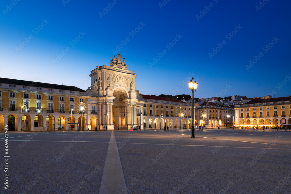 View of the Commerce Square (Praca do Comercio) and the Rua Augusta triumphal arch, in the city of Lisbon, Portugal, at dusk.
