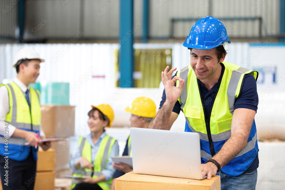 engineer or factory worker using laptop computer and showing OK gesture sign language to someone engineer or factory worker using laptop computer and showing OK gesture sign language to someone
