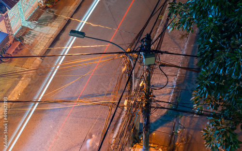 Electric cables. Top view of pole with electric wires. Chaotic cabling called 