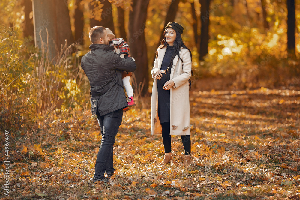 Fototapeta premium Family with little daughter in a autumn park