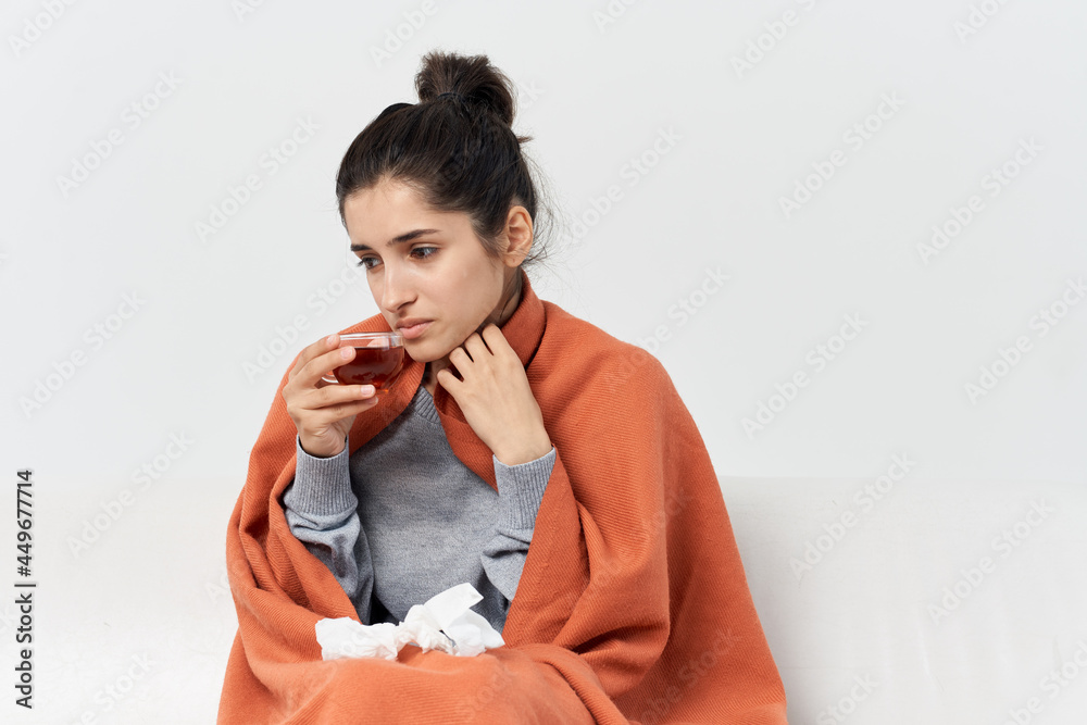 woman covering herself with a blanket at home health problems cold woman covering herself with a blanket at home health problems cold
