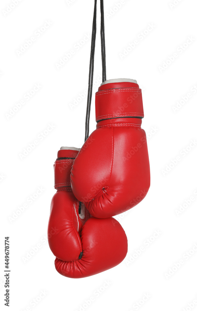 Pair of boxing gloves hanging on white background