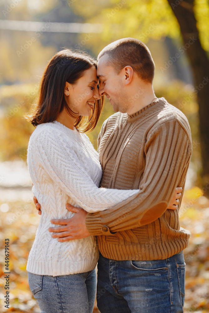 Beautiful couple spend time on a autumn park Beautiful couple spend time on a autumn park
