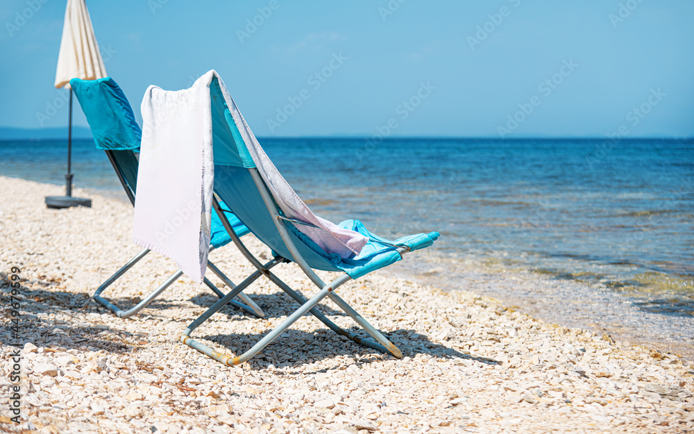Empty armchair with towel on the sea beach. Empty armchair with towel on the sea beach.