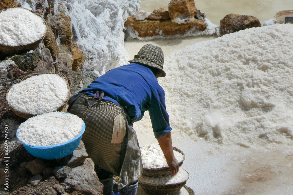 Woman working hard at the Salt Mines of Maras, Cusco, Sacred Valley, Peru, South America Woman working hard at the Salt Mines of Maras, Cusco, Sacred Valley, Peru, South America