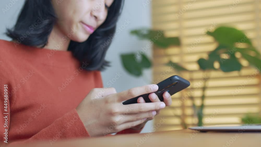 Hand of Asian girl using texting smartphone or chat happy smile Hand of Asian girl using texting smartphone or chat happy smile