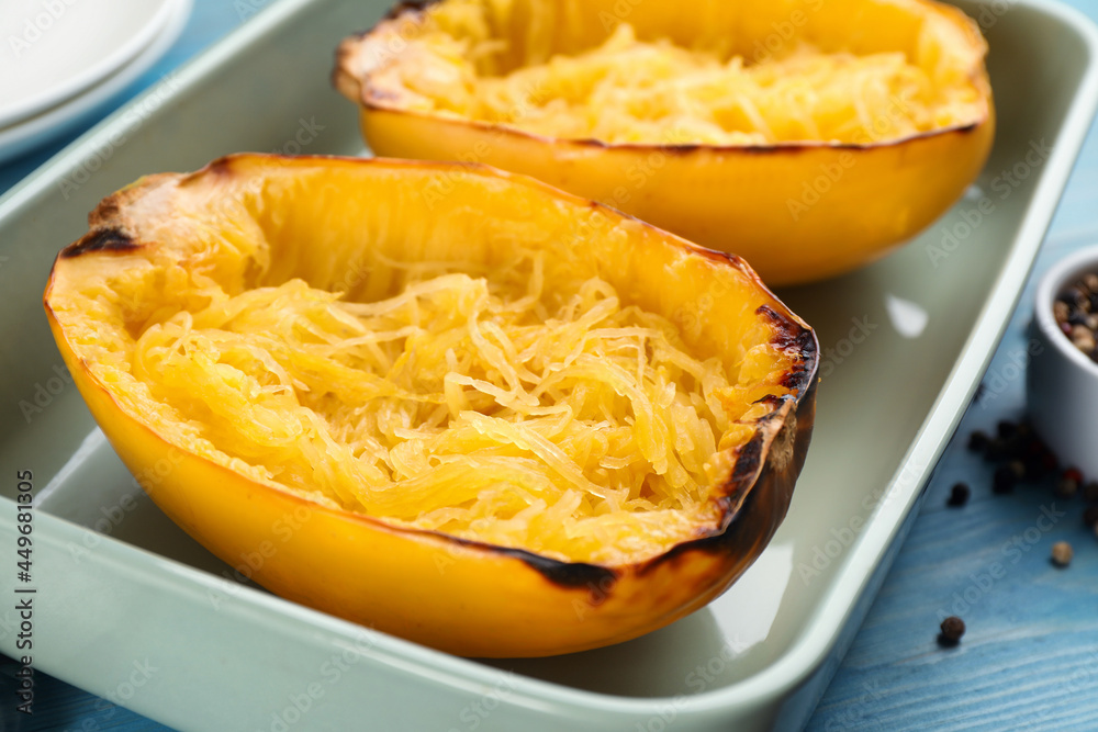 Halves of cooked spaghetti squash in baking dish on table, closeup Halves of cooked spaghetti squash in baking dish on table, closeup