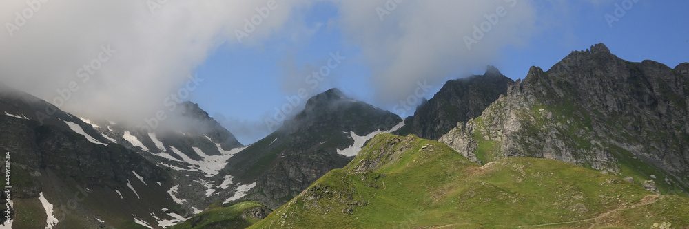 Fototapeta premium Green mountain meadow and peaks in the Pizol area.