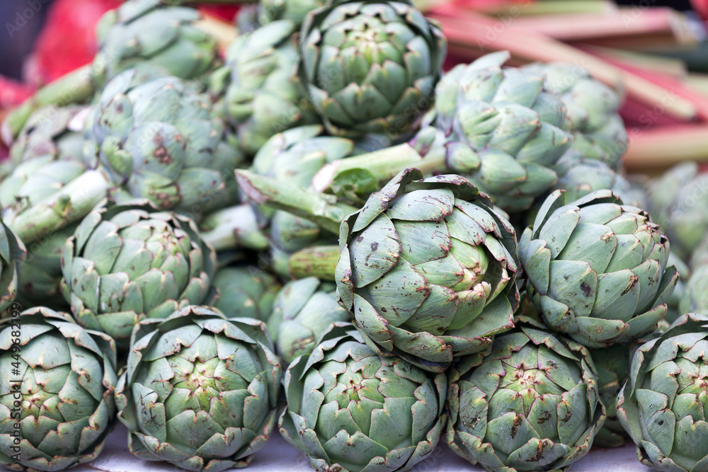Stack of artichokes on a market stall Stack of artichokes on a market stall