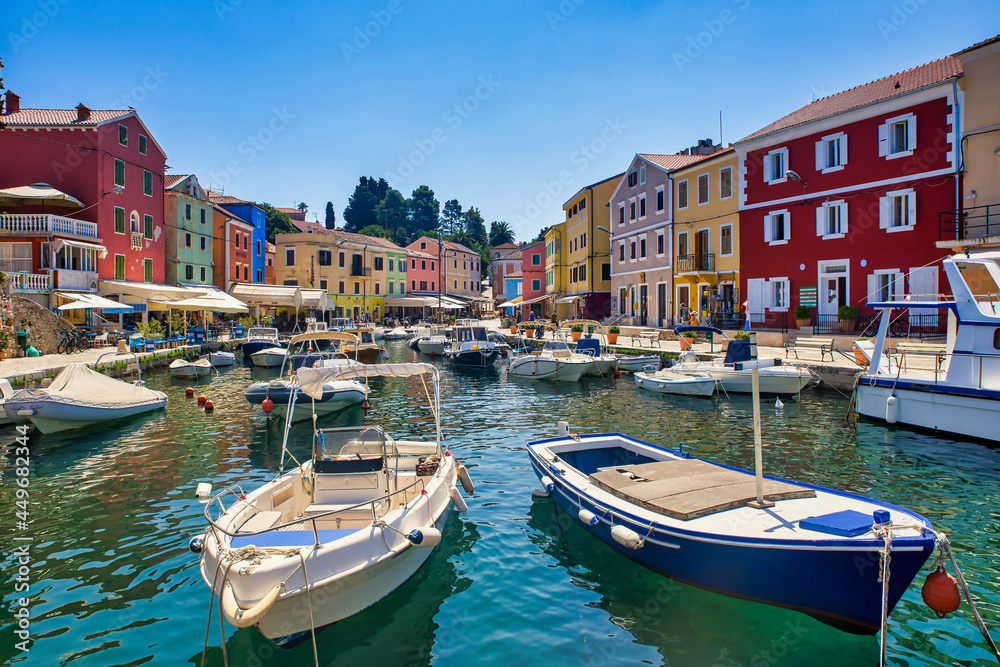 fisher boats and colorful houses in the harbor of veli losinj croatia