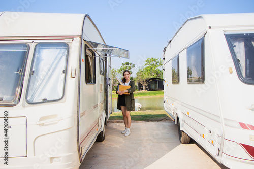 backpack solo female tourist having a happy summer vacation camping car in the morning