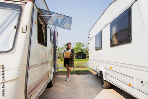 backpack solo female tourist having a happy summer vacation camping car in the morning
