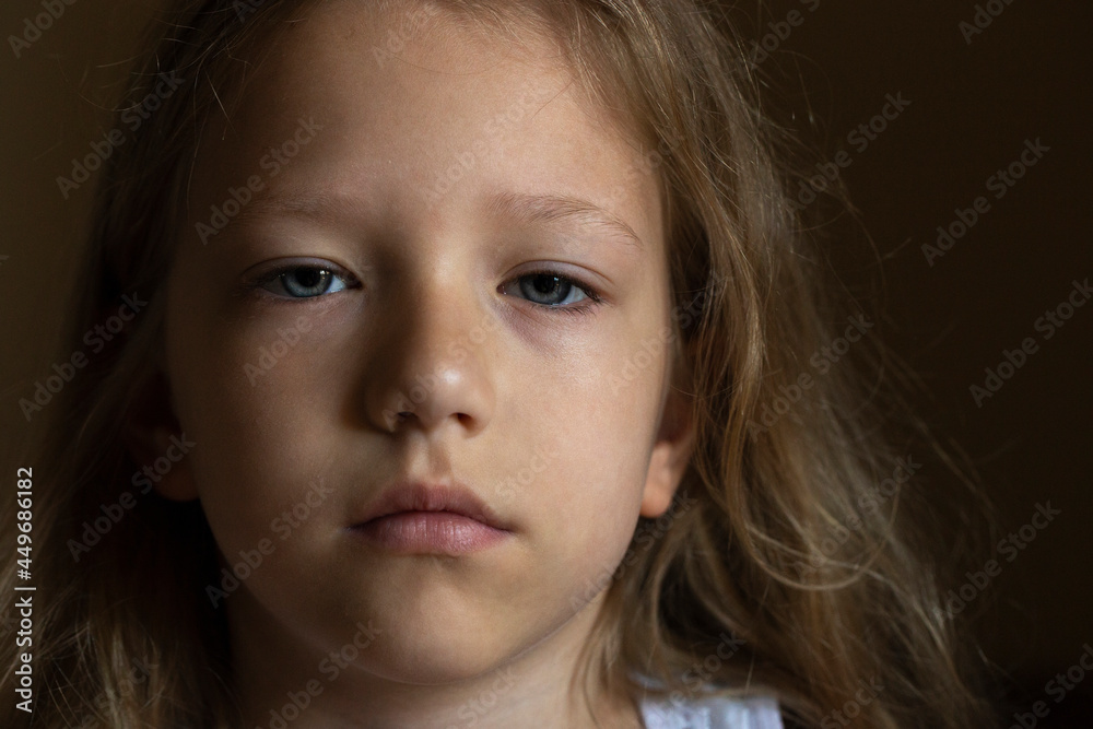 Beautiful Caucasian Girl Looks Attentively Into The Camera. Portrait Close-up. Mesmerizing Blue Eyes Beautiful Caucasian Girl Looks Attentively Into The Camera. Portrait Close-up. Mesmerizing Blue Eyes