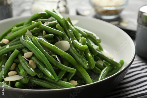 Bowl of tasty salad with green beans on table, closeup view