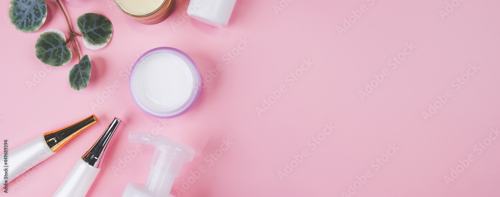 Fototapeta Mockup cosmetic bottle with cream or lotion and leaf isolated on pink background, mock up package for advertising, skincare or cosmetology, top view, flat lay, skin care and treatment with product.