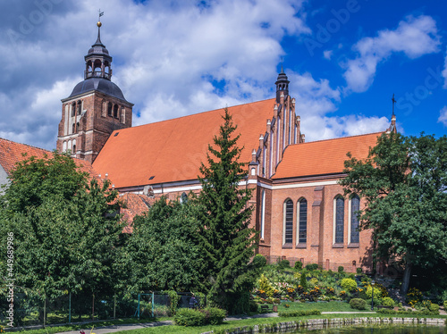 Exterior of St Anne and St Stephen Roman Catholic Church over pond in Barczewo town, Warmia region, Poland