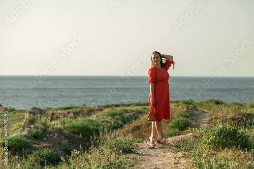 A girl in a red dress in nature. The expanses of the Crimean peninsula.