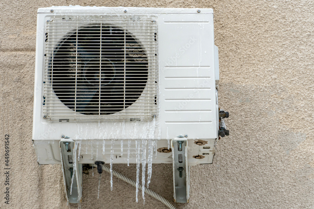 An outdoor air conditioner unit installed on the outer wall of a