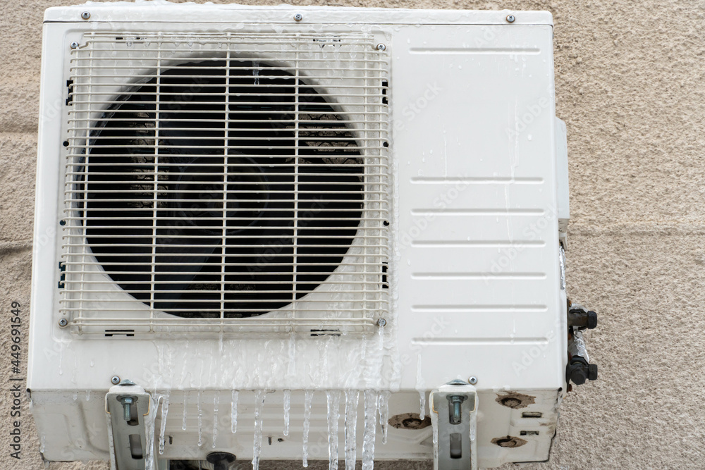 An outdoor air conditioner unit installed on the outer wall of a