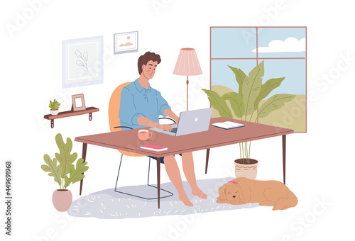 Young man working with laptop in his modern home office. Cute dog lying on the carpet and waiting for a walk