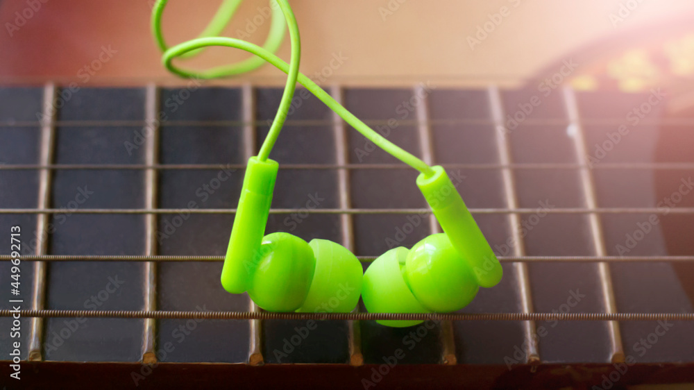Green vacuum headphones and guitar