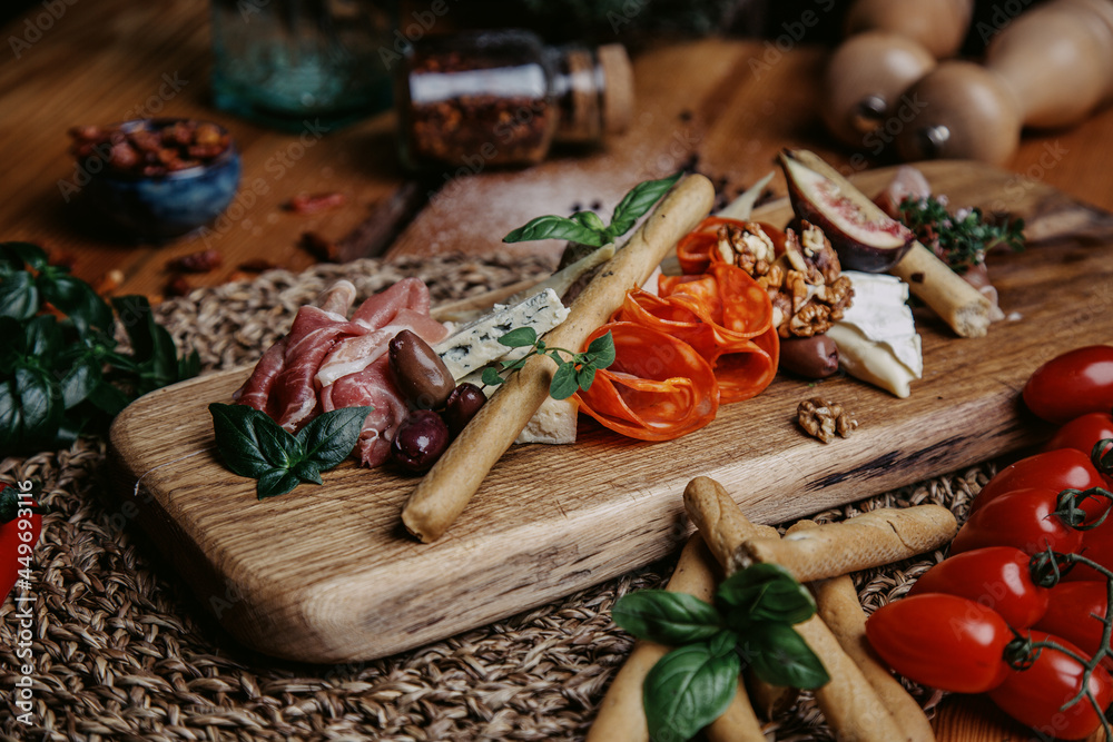 tapas italiano snacks chorizo olives spices and herbs on wooden table
