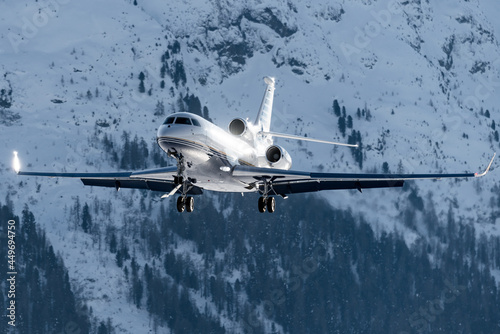 Luxury private jet approaching the engadin valley in the Swiss alps