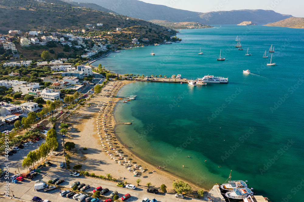 Aerial view of the public beach in the resort town of Elounda on the island of Crete (Greece)