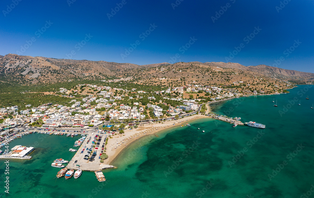 ELOUNDA, CRETE/GREECE - JULY 16 2021: Aerial view of the port and resort town of Elounda on the Greek island of Crete