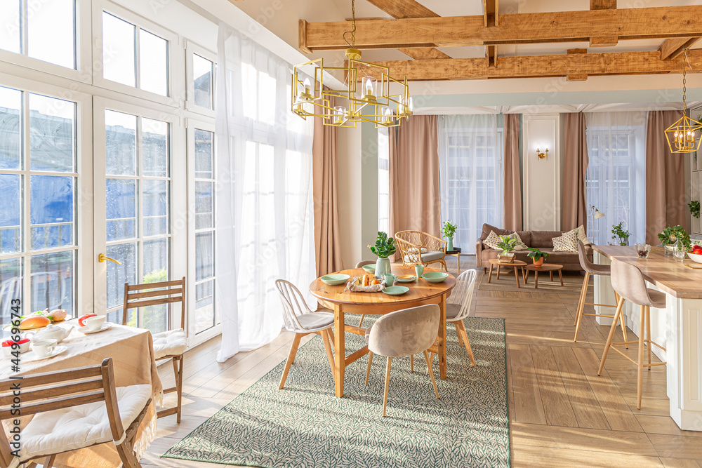 Fototapeta premium modern expensive luxurious open-plan apartment. Rich Scandinavian-style interior with wooden beams on the ceiling in pastel colors