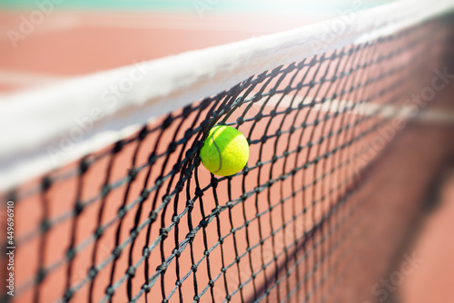 Tennis ball hits in the net during game. © Dmytro_Mykhailov