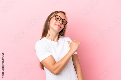 Young English woman isolated on pink background proud and self-satisfied