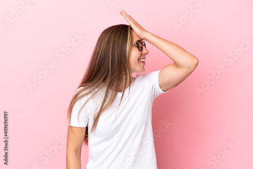 Young English woman isolated on pink background has realized something and intending the solution