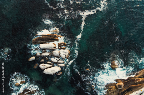 Aerial view over boulders in the ocean