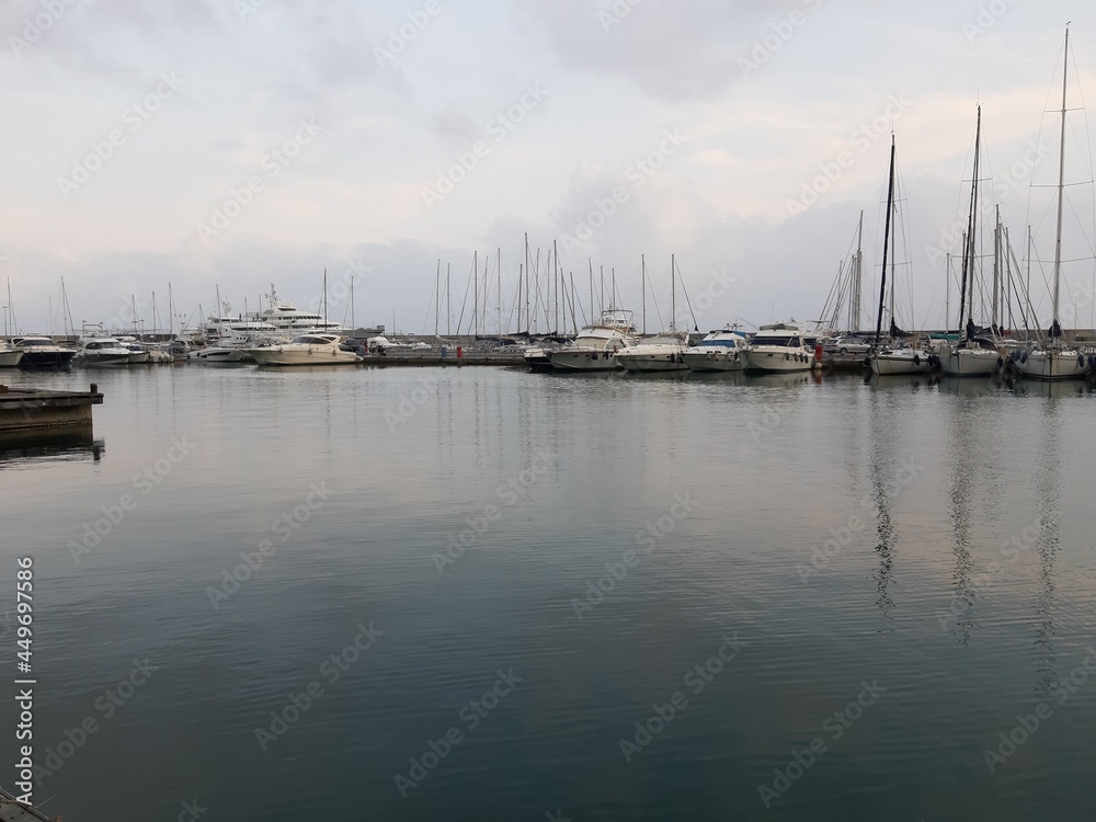 Genova, Italy - July 26, 2021: Travelling around the ligurian seaside. Panoramic view to the seaside and the old port. Beautiful view to the port with some boats in summer days.