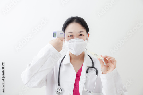 Asian female doctor is recommending medication  wearing a mask and checking body temperature while examine the patient via video call. Health care and prevention COVID-19 strategy Coronavirus concept
