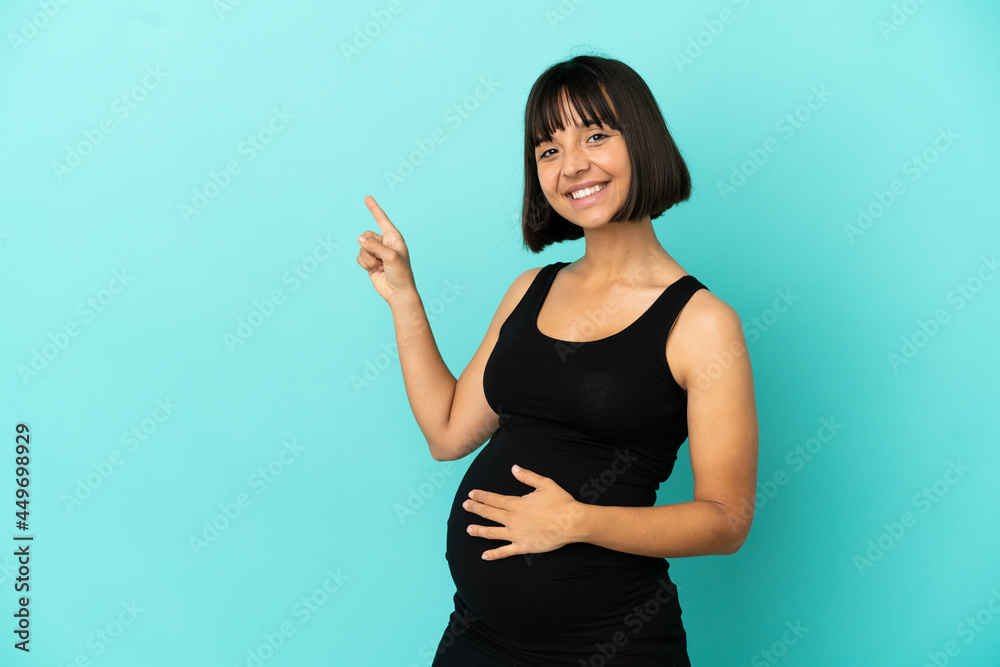 Woman over isolated background pregnant and pointing to the lateral Woman over isolated background pregnant and pointing to the lateral