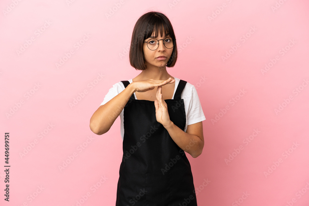 Restaurant waiter over isolated pink background making time out gesture Restaurant waiter over isolated pink background making time out gesture