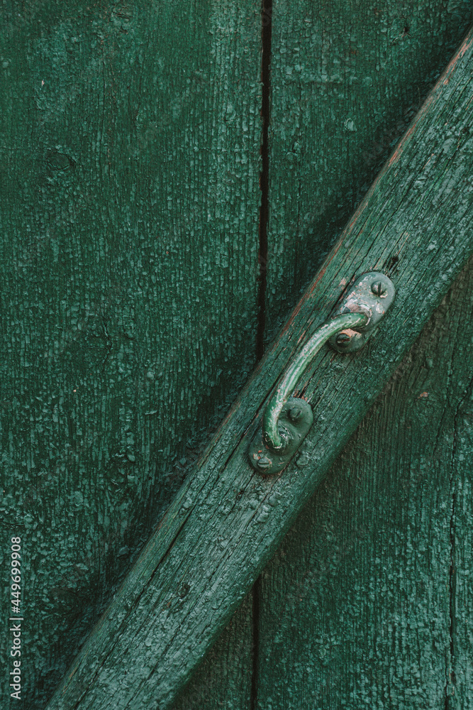 handle on a green wooden door. Texture