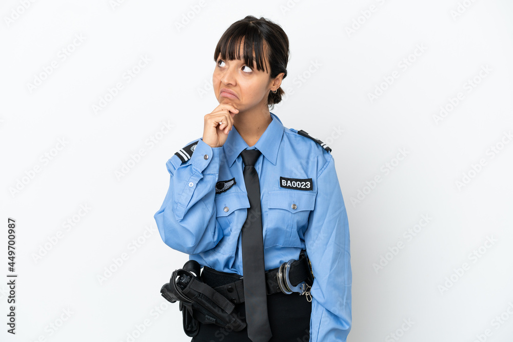 Young police mixed race woman isolated background and looking up Young police mixed race woman isolated background and looking up