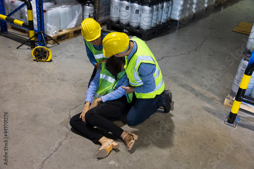 Coworker helping another who collapse on the ground due to accident and personal illness for safety workplace and emergency health care medical first aid in industrial site