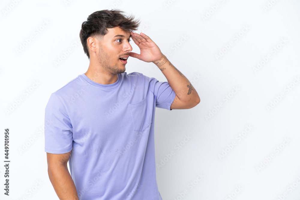 Young caucasian handsome man isolated on white background with surprise expression while looking side Young caucasian handsome man isolated on white background with surprise expression while looking side