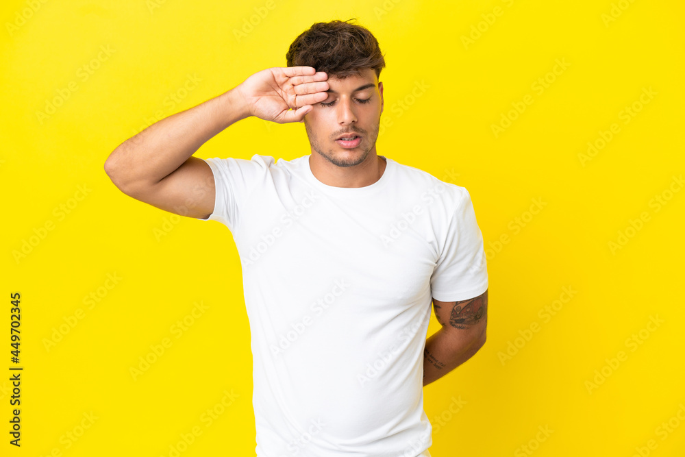 Young caucasian handsome man isolated on yellow background with tired and sick expression Young caucasian handsome man isolated on yellow background with tired and sick expression