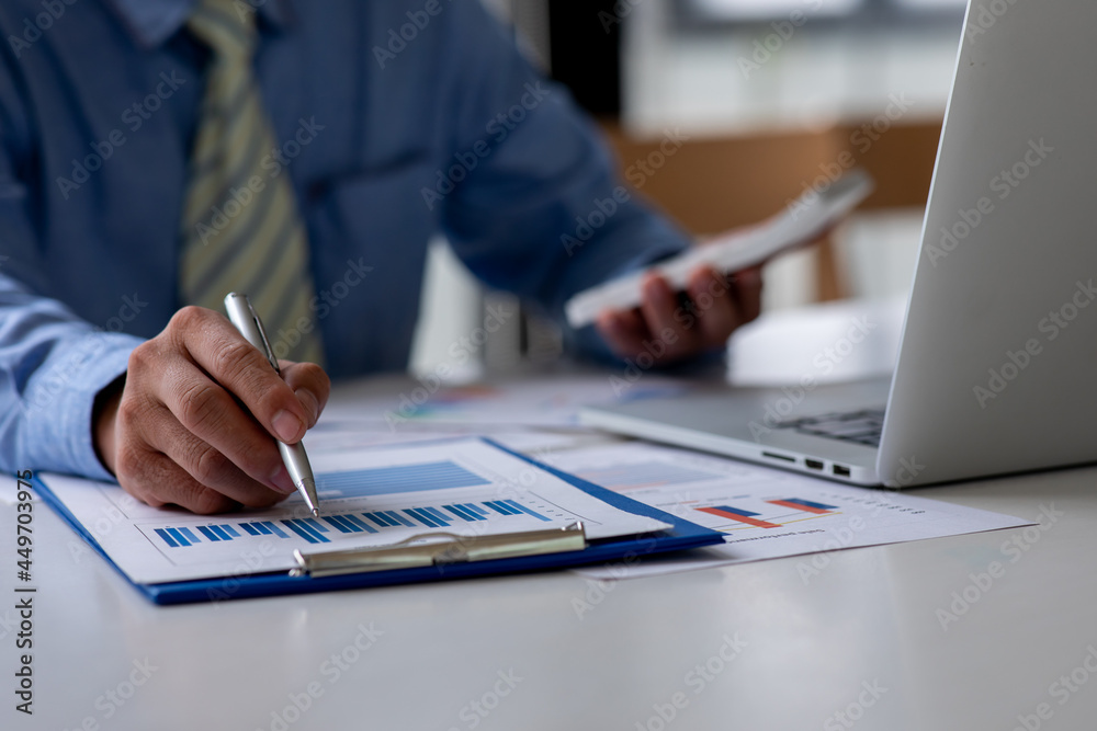 Business man hand hold documents with financial statistic stock photo,discussion and analysis data the charts and graphs.Market research reports Accounting Finance concept Business man hand hold documents with financial statistic stock photo,discussion and analysis data the charts and graphs.Market research reports Accounting Finance concept