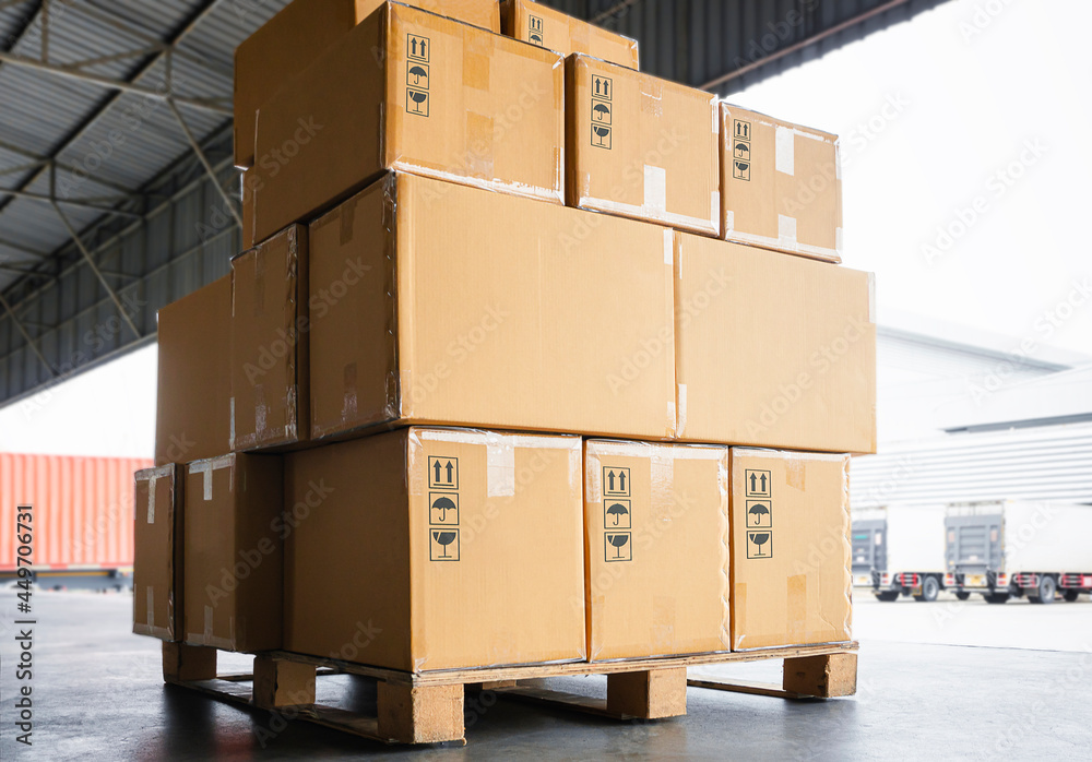 Stack of Package Boxes on Pallet at The Storage Warehouse. Shipping Warehouse Logistics Transport. Stack of Package Boxes on Pallet at The Storage Warehouse. Shipping Warehouse Logistics Transport.