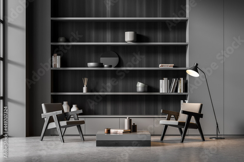Dark grey niche shelf, woode details, armchairs with lamp in seating area