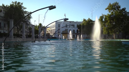 Fuente en forma de catavino con agua en el centro de una ciudad de andalucia photo