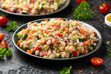 Quinoa white bean salad with cherry tomatoes, cucumber, red onion and herbs. Healthy vegan food
